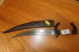 A vintage carved wooden and bone dagger