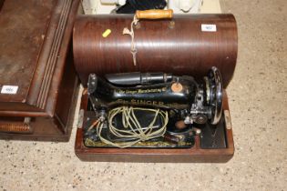 A Singer sewing machine in oak case