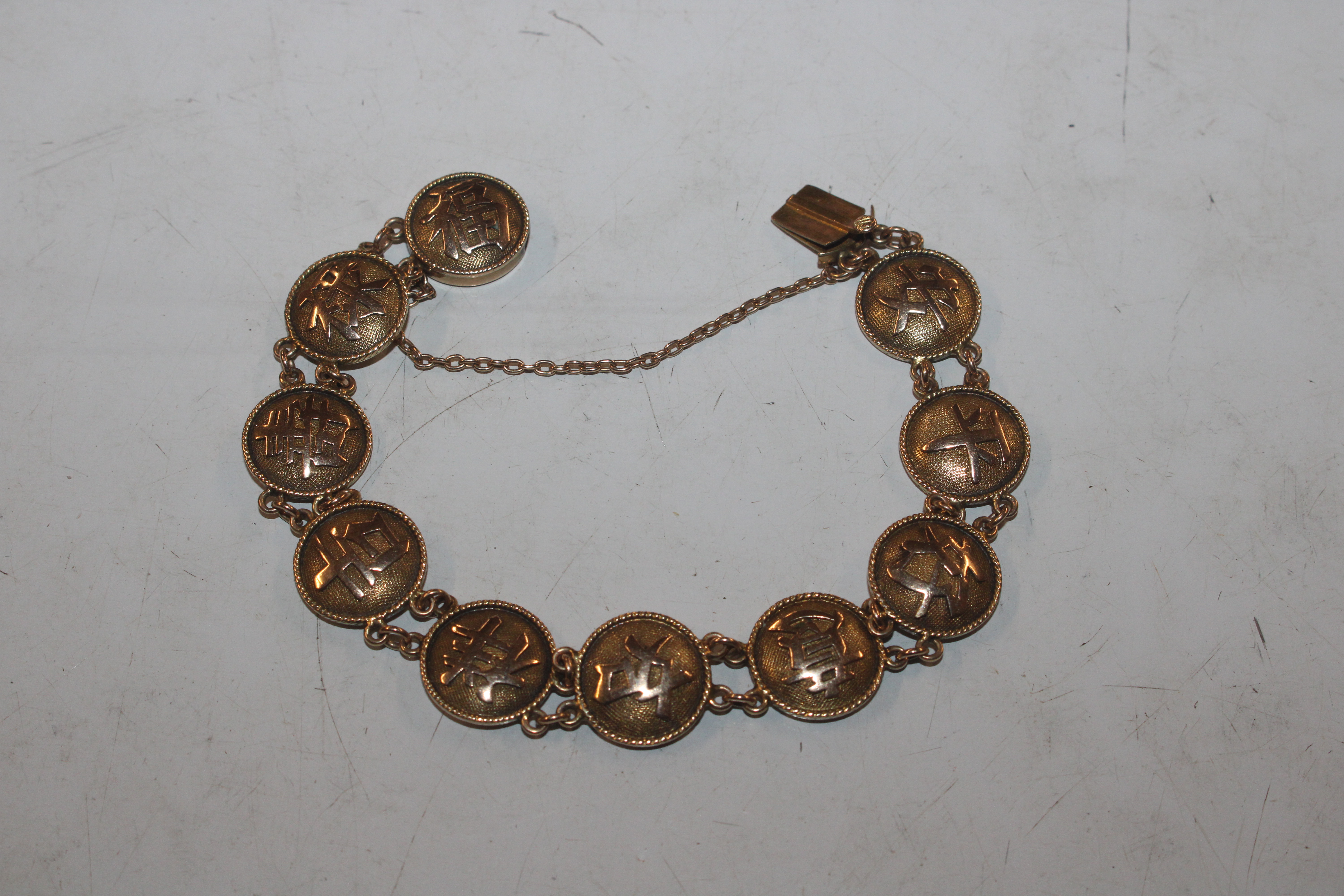 A Chinese yellow metal bracelet marked 18, approx.