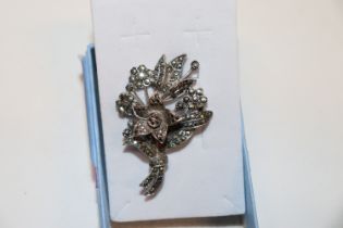 An unusual silver and marcasite brooch with centra