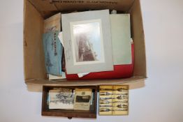 A box containing various ephemera, albums of cigar