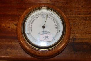 An oak cased aneroid barometer by J.H. Steward of