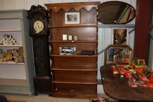 An oak graduated open fronted bookcase