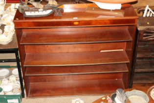 A mahogany open fronted bookcase with three adjust