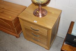 A light wood chest of three drawers