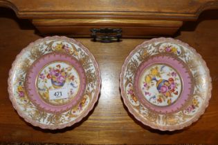 A pair of pink floral decorated and gilt heightene