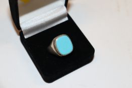 A silver and turquoise set signet ring