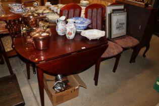 A modern laminated drop leaf kitchen table and fou