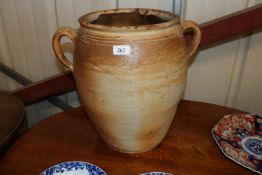 A glazed pottery twin handled urn