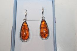 A pair of Hallmarked Sterling silver and amber dro