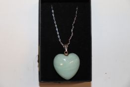 A hardstone heart shaped pendant, hung to a 925 si