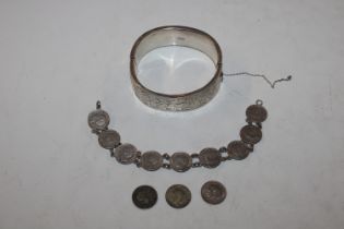 A silver coin bracelet and a silver snap bangle