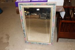 A decorative framed bevel edged wall mirror