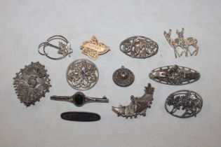 A box of 925 silver and other brooches