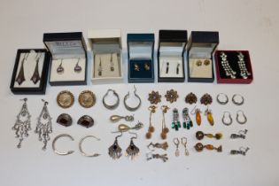 A box containing numerous pairs of decorative ear-