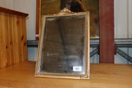 A gilt framed bevel edged easel mirror