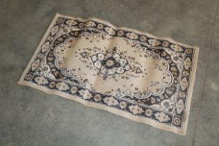An approx. 3'5" x 2' floral patterned rug