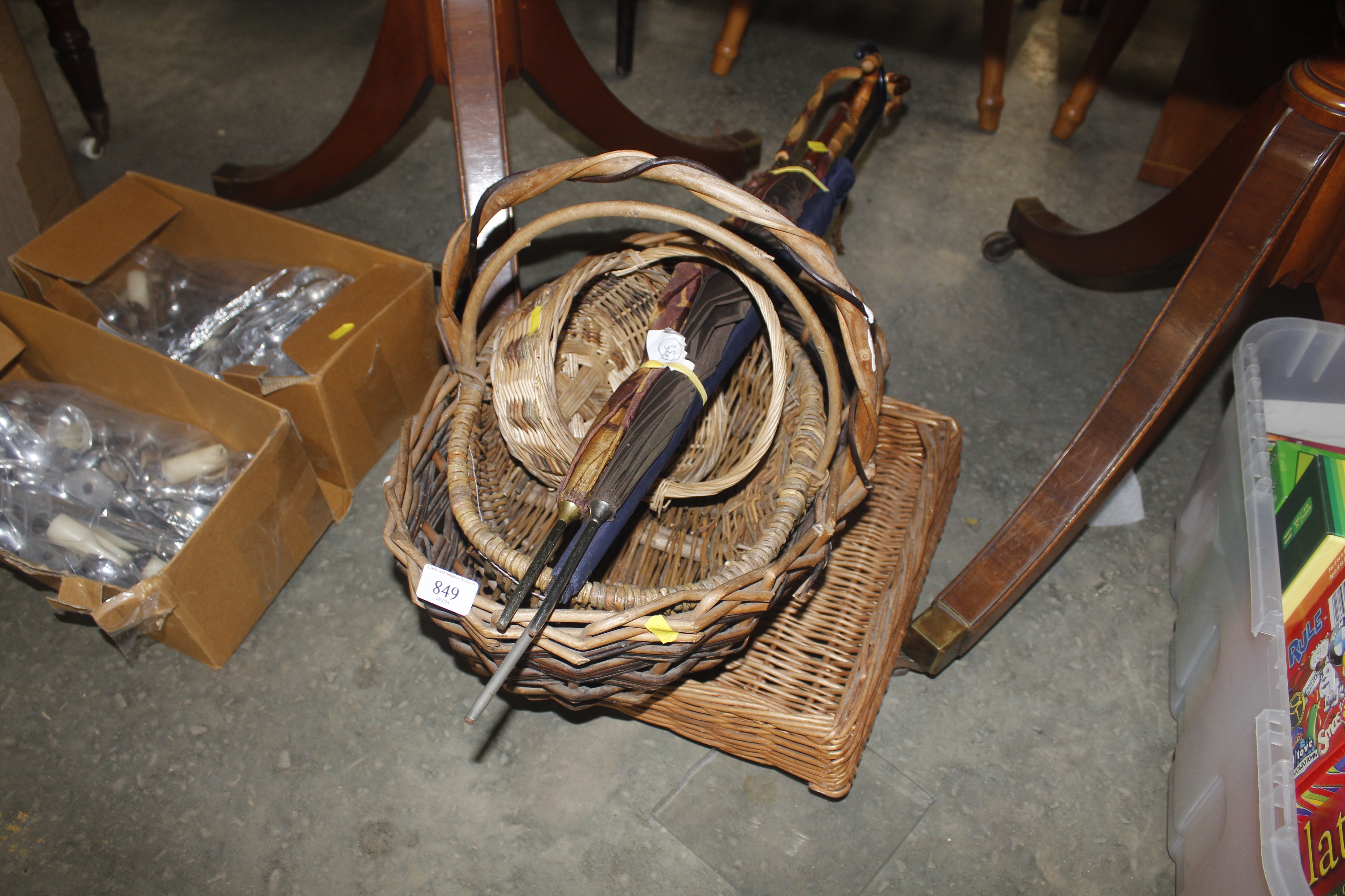 A collection of basket ware and umbrellas
