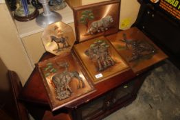 A collection of copper plaques decorated with animals and windmill