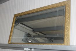 A large gilt framed and bevel edged wall mirror