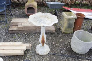 A cast metal bird bath