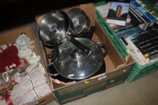 A box of stainless steel saucepans