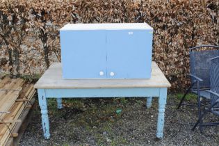 A part painted pine table and kitchen cabinet