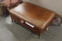 A leather upholstered Ottoman
