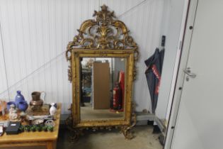 An ornate gilt framed wall mirror