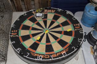 A Winmau dartboard and darts