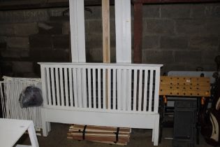 A modern white painted bedstead