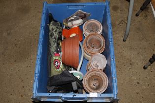 A box containing a child's suitcase and various te