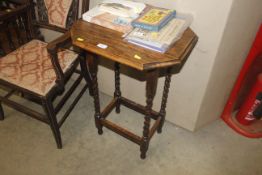 An oak occasional table raised on barley twist sup