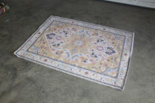 An approx. 5'6" x 3'11" floral patterned rug