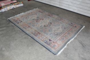 An approx. 7'10" x 5'3" floral patterned rug