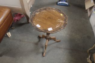 A wine table raised on tripod base