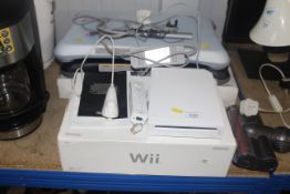 A Nintendo Wi console and Fit board