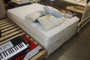 A double divan bed with Sealy mattress