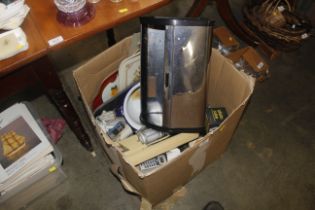 A box containing cutlery, bread bin, kitchen utens