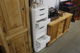 A modern white chest fitted nine drawers