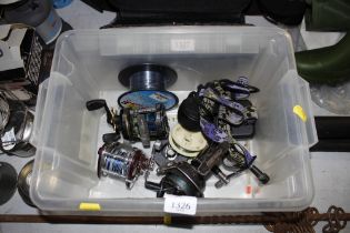 A box containing fishing reels and headlamp