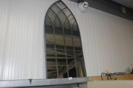 An arched framed mirror (150)