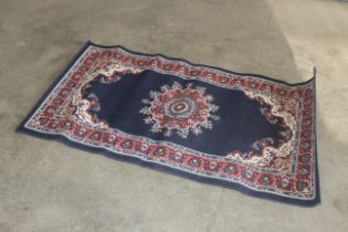An approx. 4'11" x 2'8" floral patterned rug