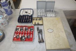 A collection of boxed and cased cutlery; and table