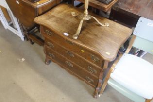 An oak serpentine fronted chest fitted three drawe