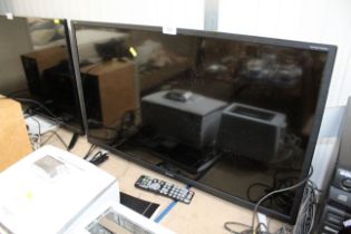 A Sharp flat screen television with remote control