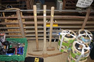 Two sledge hammers and pick axe