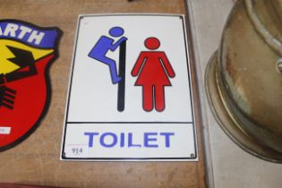 An enamel toilet sign (242)