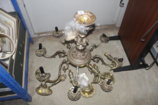 A brass eight branch chandelier and three twin bra