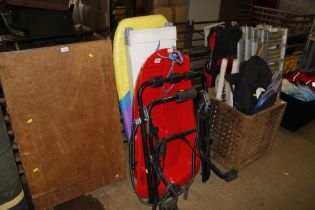 A bike rack, two plastic sledges, a bodyboard etc